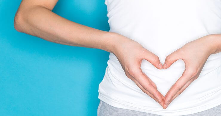 gut-health_blog Person with hands over gut